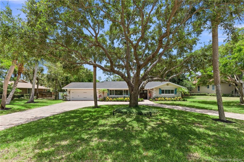 3 Mandalay Road Stuart, FL 34996 - Photo 55 of 65 a house view with a sitting space and garden