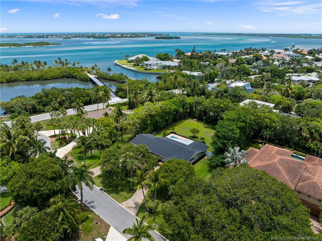 3 Mandalay Road Stuart, FL 34996 - Photo 64 of 65 an aerial view of a house with a garden and lake view