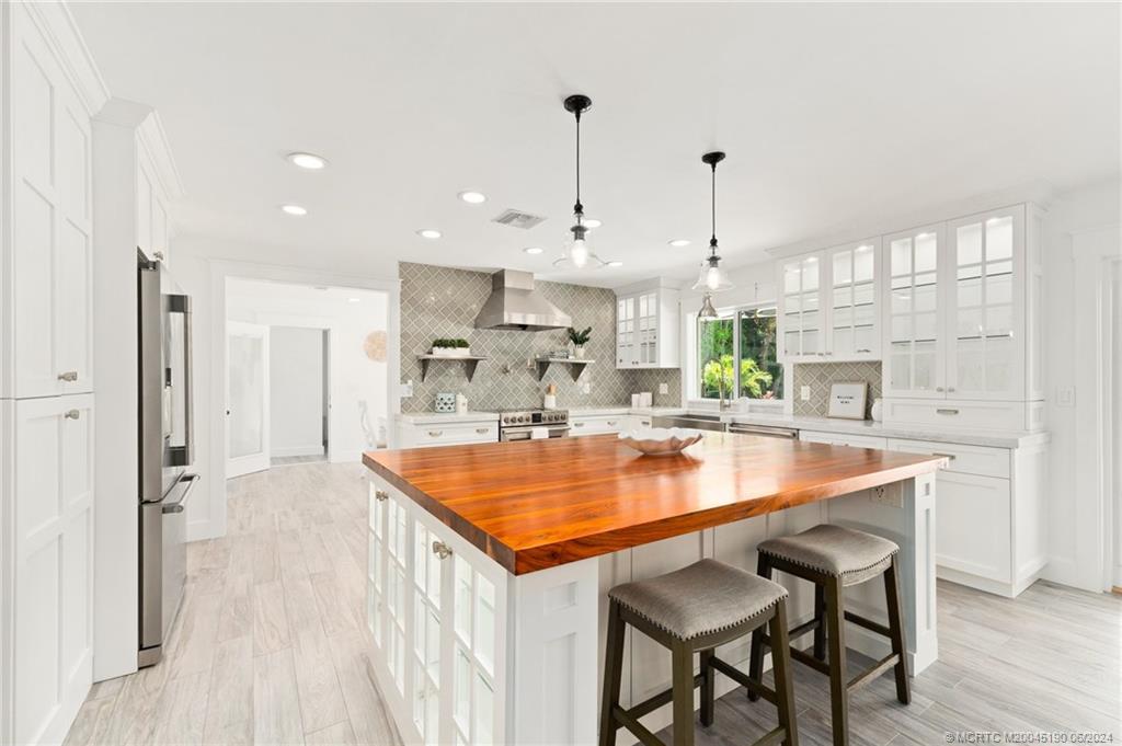 3 Mandalay Road Stuart, FL 34996 - Photo 10 of 65 a kitchen with stainless steel appliances granite countertop a sink a stove and a refrigerator