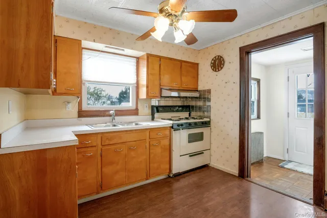 a kitchen with stainless steel appliances a stove a sink and a refrigerator