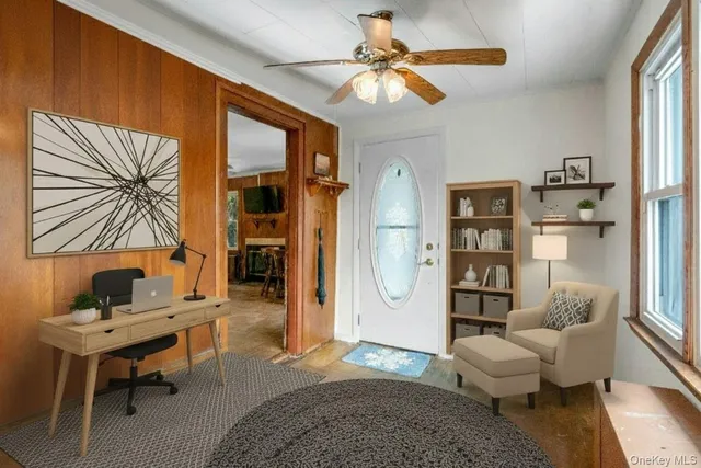 a living room with furniture a rug and white walls