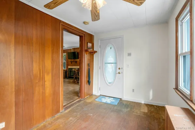 a view of a room with wooden floor and windows