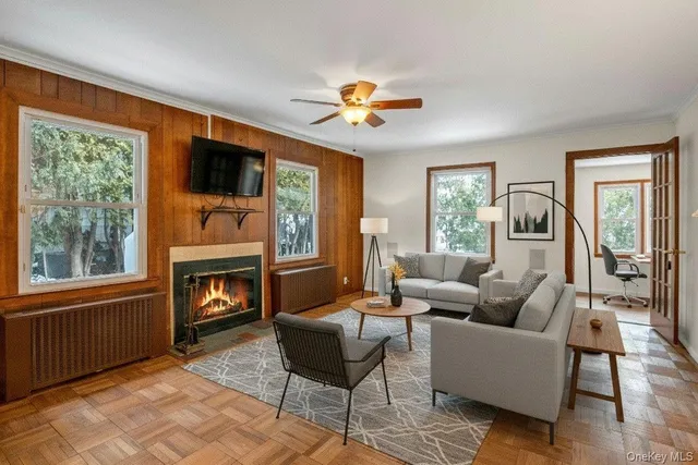 a living room with furniture a fireplace and a flat screen tv