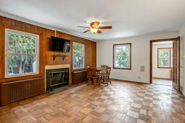 a view of a livingroom with furniture a flat screen tv and a fireplace
