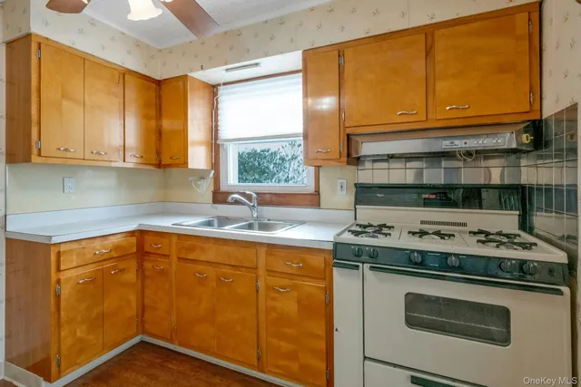 a kitchen with a sink stove and cabinets
