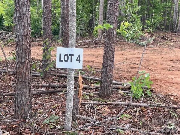 a sign that is sitting in the forest