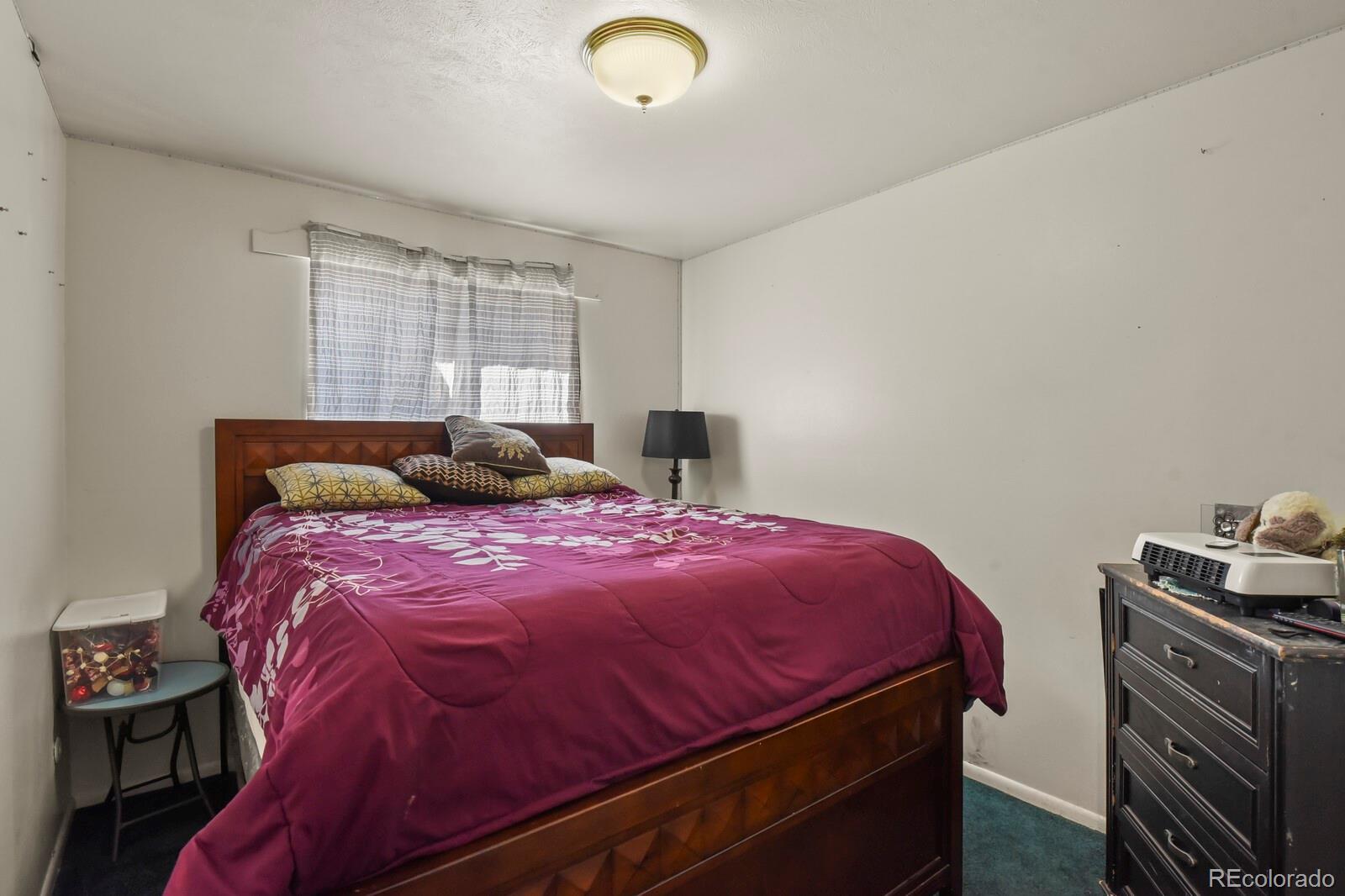 3400 West Mountain Road Englewood, CO 80110 - Photo 13 of 22 a bedroom with a bed and a window
