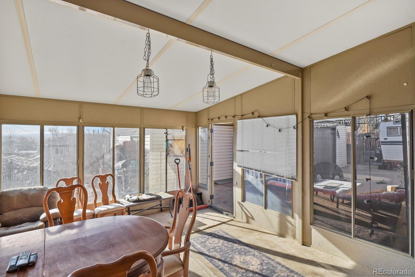3400 West Mountain Road Englewood, CO 80110 - Photo 19 of 22 a living room with furniture and a floor to ceiling window