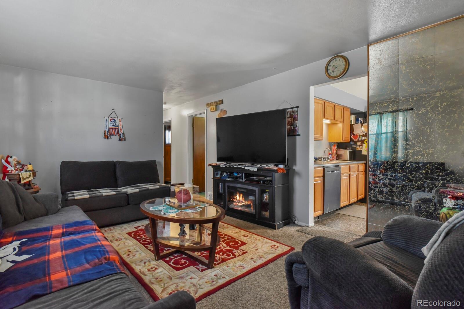 3400 West Mountain Road Englewood, CO 80110 - Photo 2 of 22 a living room with furniture and a flat screen tv