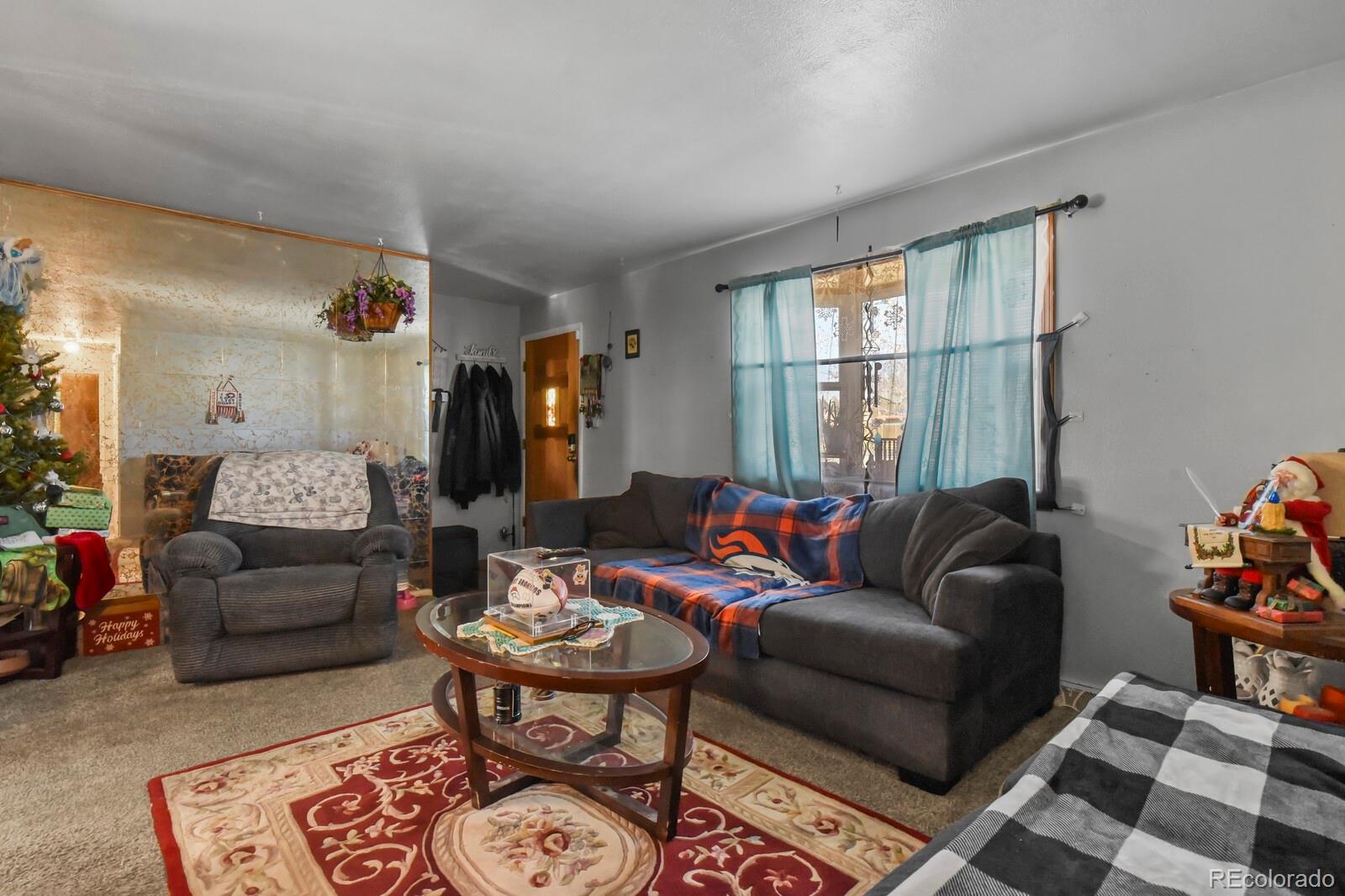 3400 West Mountain Road Englewood, CO 80110 - Photo 3 of 22 a living room with furniture and a large window