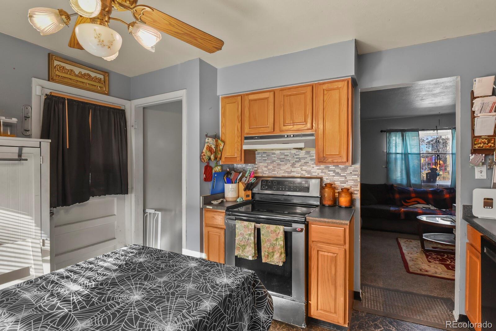 3400 West Mountain Road Englewood, CO 80110 - Photo 6 of 22 a kitchen with a stove a refrigerator and cabinets