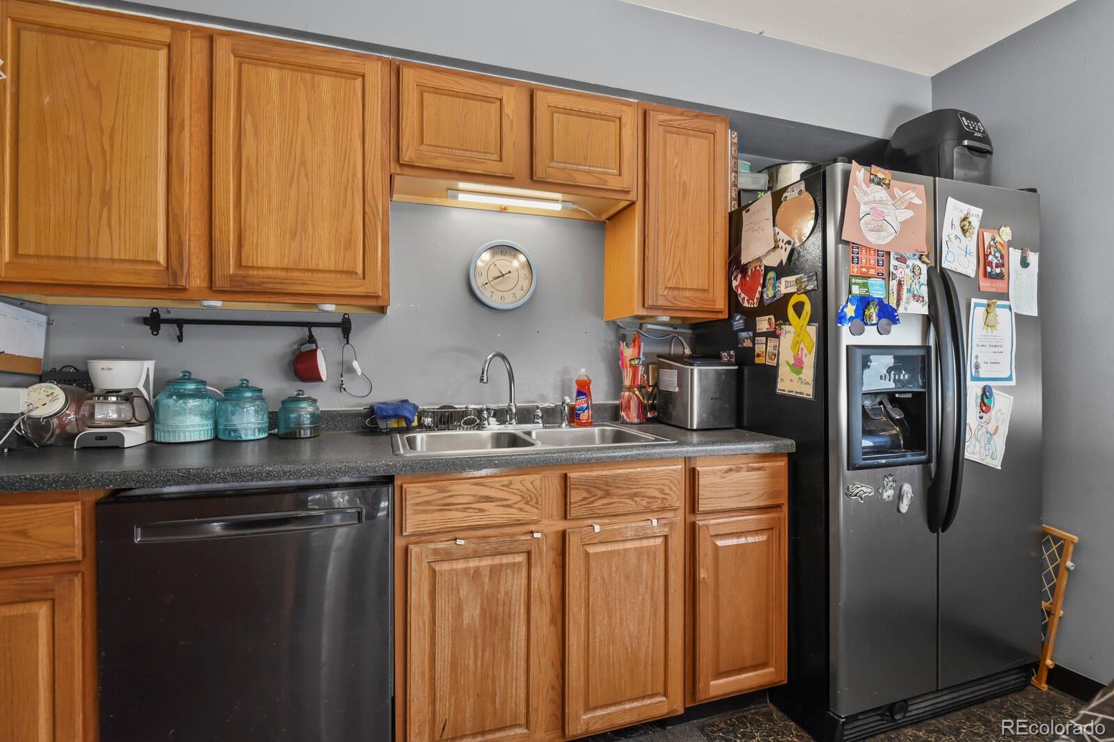 3400 West Mountain Road Englewood, CO 80110 - Photo 8 of 22 a kitchen with stainless steel appliances granite countertop a refrigerator and a stove