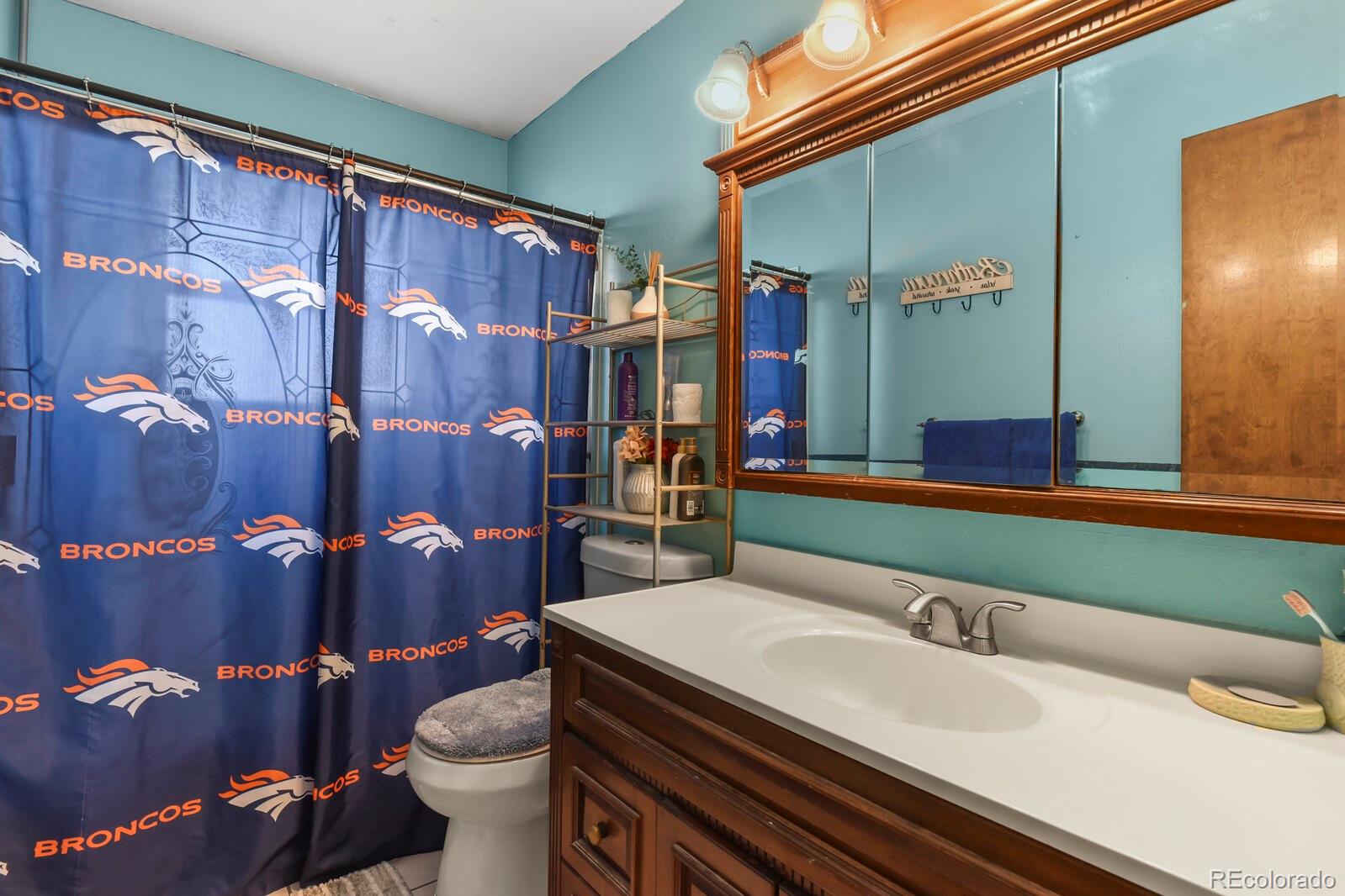 3400 West Mountain Road Englewood, CO 80110 - Photo 9 of 22 a bathroom with a granite countertop sink and a mirror
