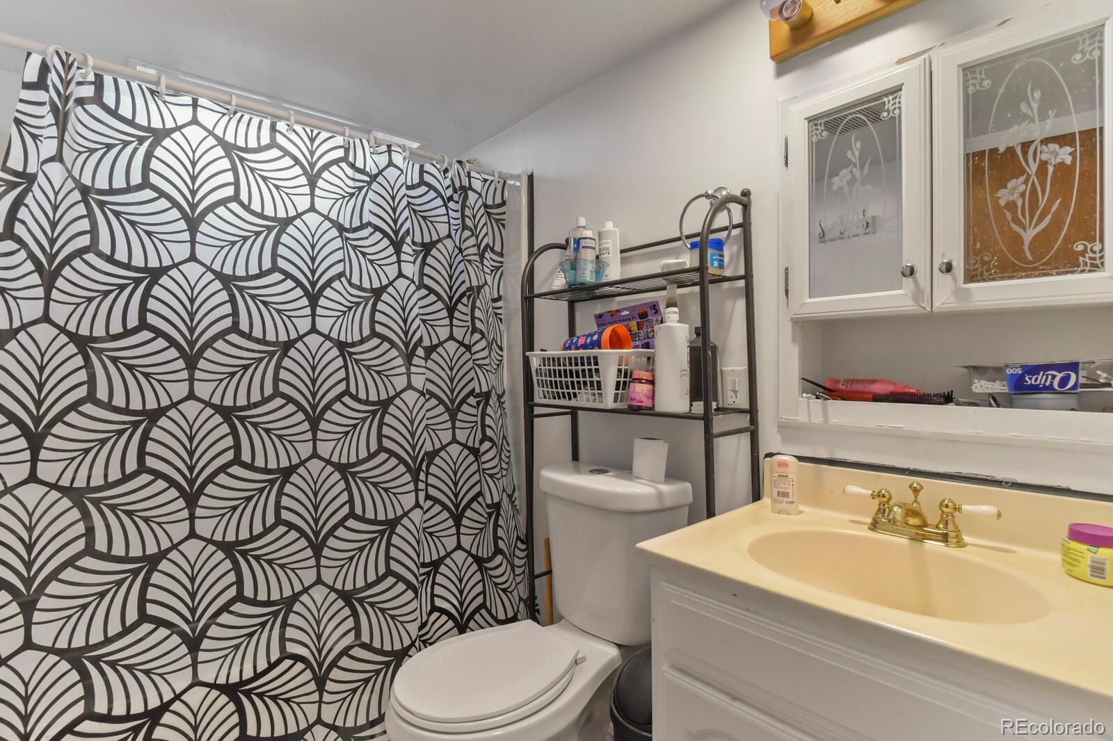 3400 West Mountain Road Englewood, CO 80110 - Photo 10 of 22 a bathroom with a sink toilet and shower