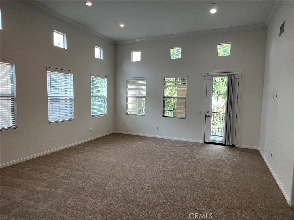 104 Rose Arch Irvine, CA 92620 - Photo 5 of 12 an empty room with windows and closet