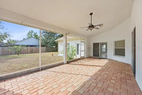 a view of a livingroom with furniture and a ceiling fan