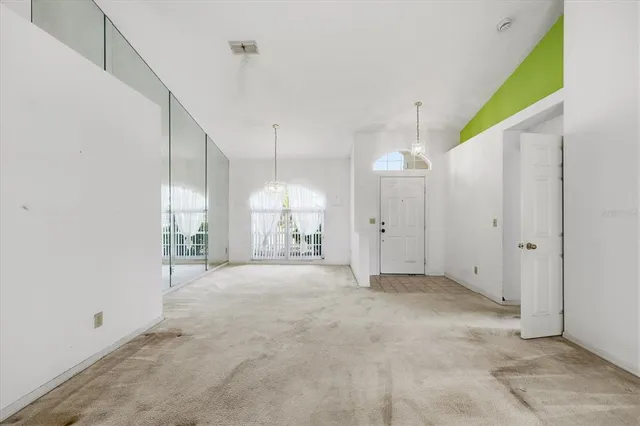 a view of an empty room with a chandelier