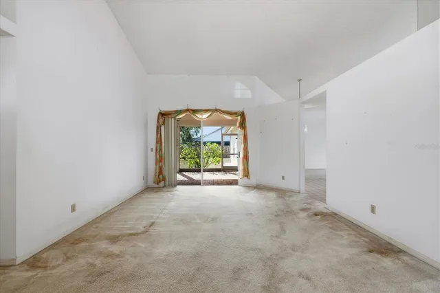 an empty room with windows and garden