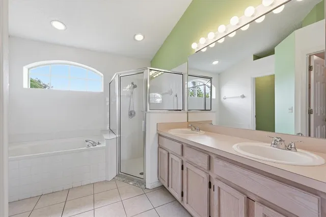 a bathroom with a granite countertop sink a mirror and a bathtub