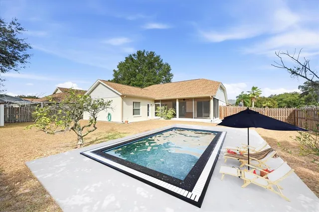 a view of a patio with a table and chairs under an umbrella