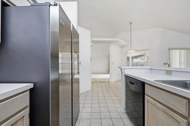 a kitchen with stainless steel appliances granite countertop a sink and a refrigerator