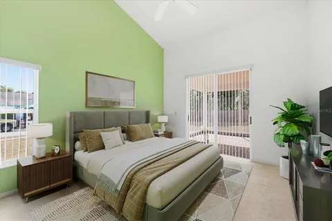 a bedroom with a bed and a potted plant