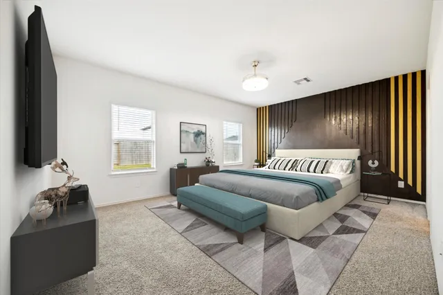 a bedroom with a bed and a couch