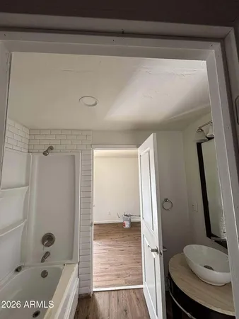 a bathroom with a tub and a shower