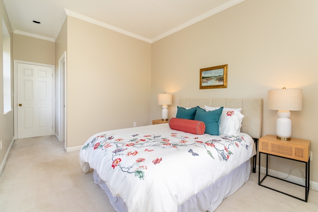 60e Glen Road, Unit 306 Brookline, MA 02445 - Photo 19 of 27 a bedroom with a bed and a lamp