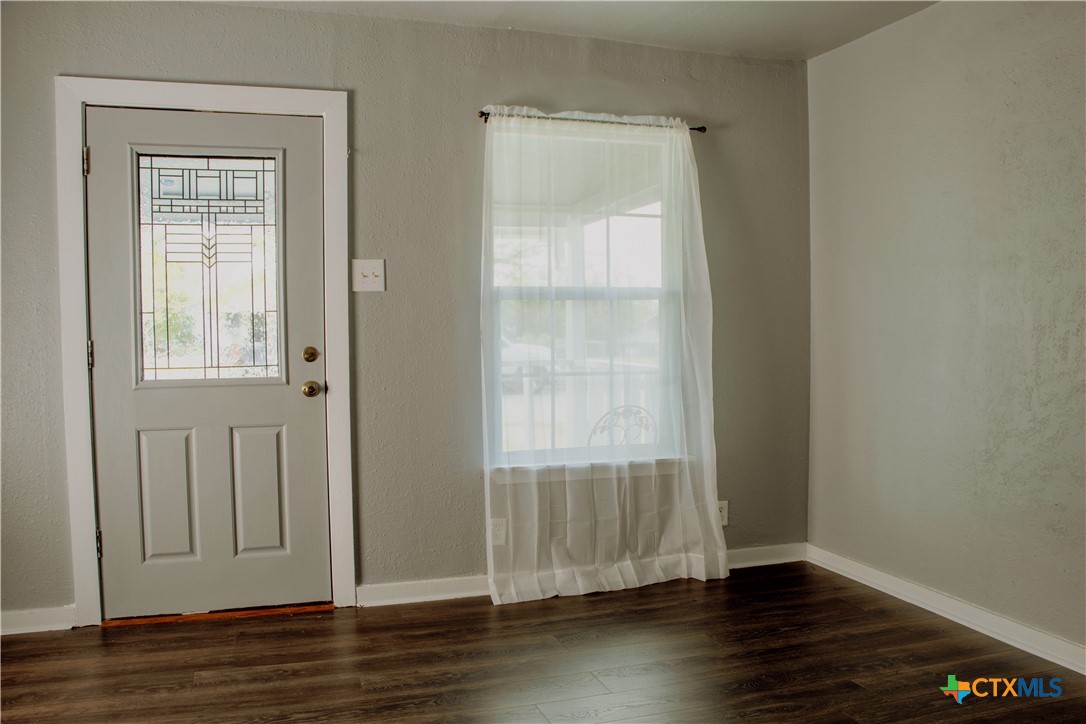 1407 South 7th Street Temple, TX 76504 - Photo 4 of 36 an empty room with wooden floor closet and windows