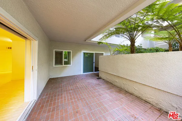 a view of a room with wooden floor and a yard