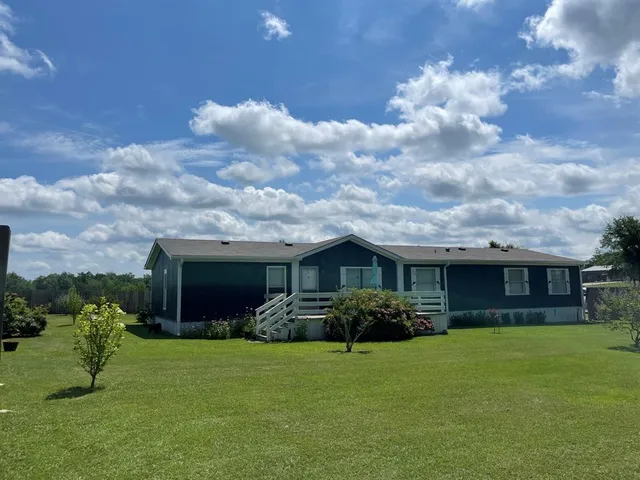 a front view of house with a garden