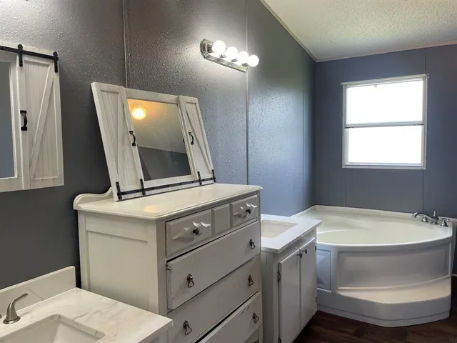 a view of bathroom with a toilet sink and mirror