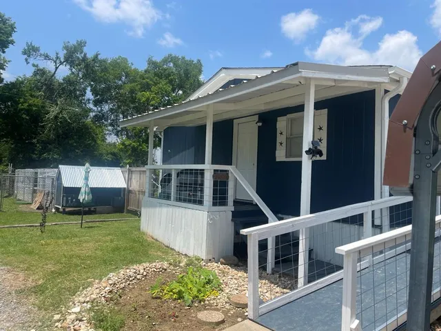 a view of a house with a yard and sitting area