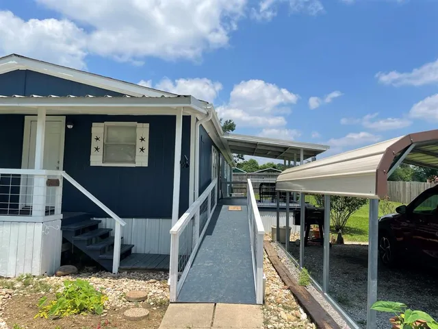 a view of a house with wooden deck