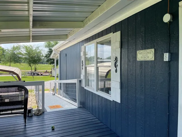 a view of a deck with wooden floor and outdoor seating