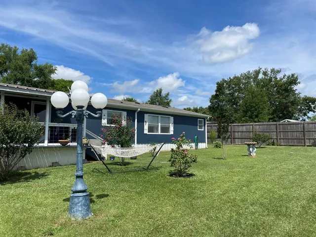 a backyard of a house with barbeque oven table and chairs