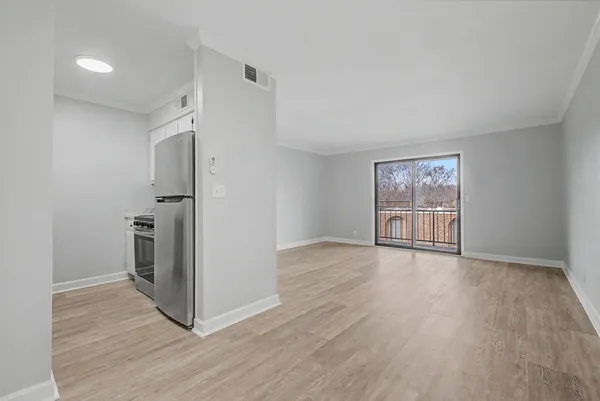 an empty room with wooden floor and a window
