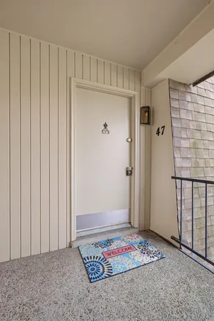 a view of a yard with a tiny house and slide