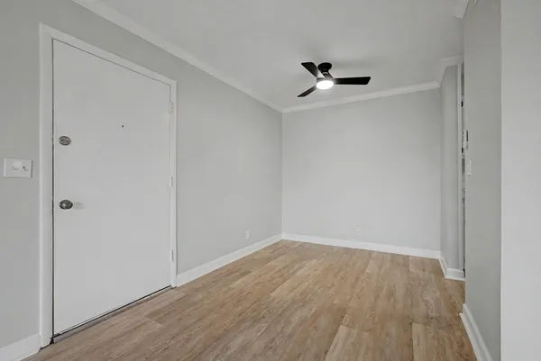 a view of a room with wooden floor