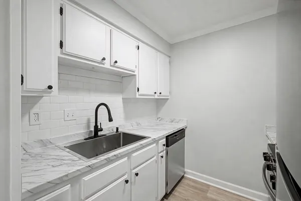 a kitchen with a sink and cabinets