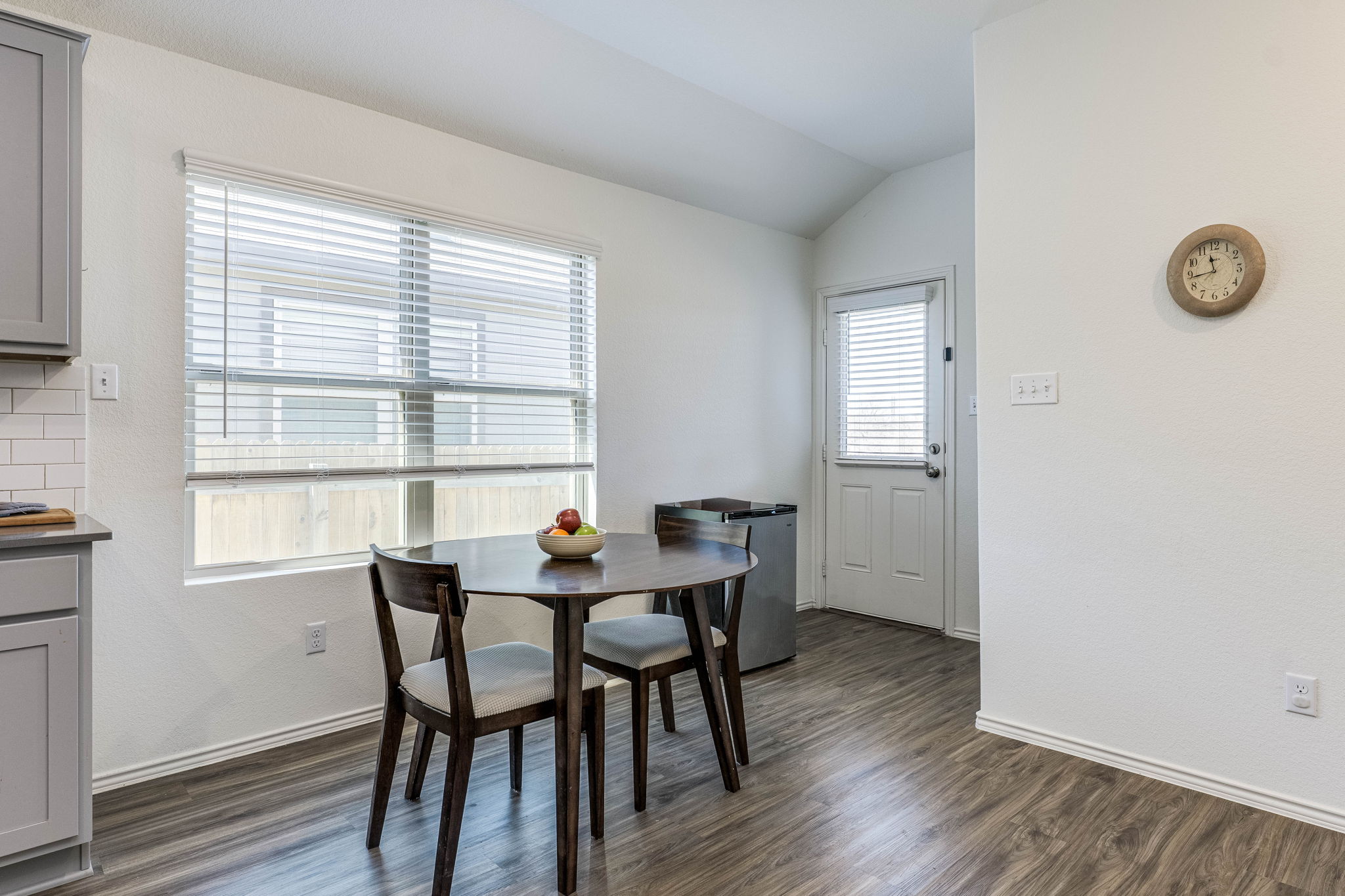 557 Greatest Gift Way Jarrell, TX 76537 - Photo 16 of 39 Dining room featuring dark wood finished floors and vaulted ceiling