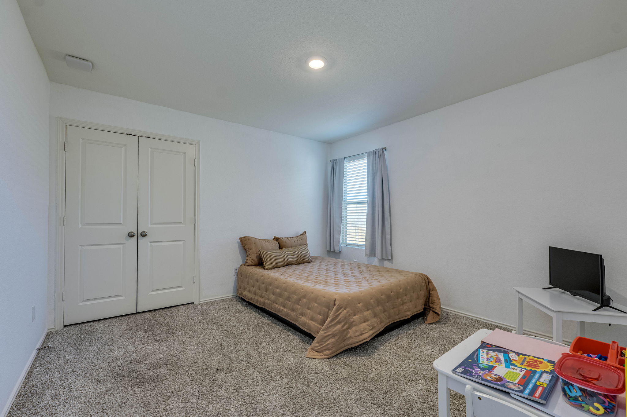 557 Greatest Gift Way Jarrell, TX 76537 - Photo 17 of 39 Carpeted bedroom featuring a closet and baseboards