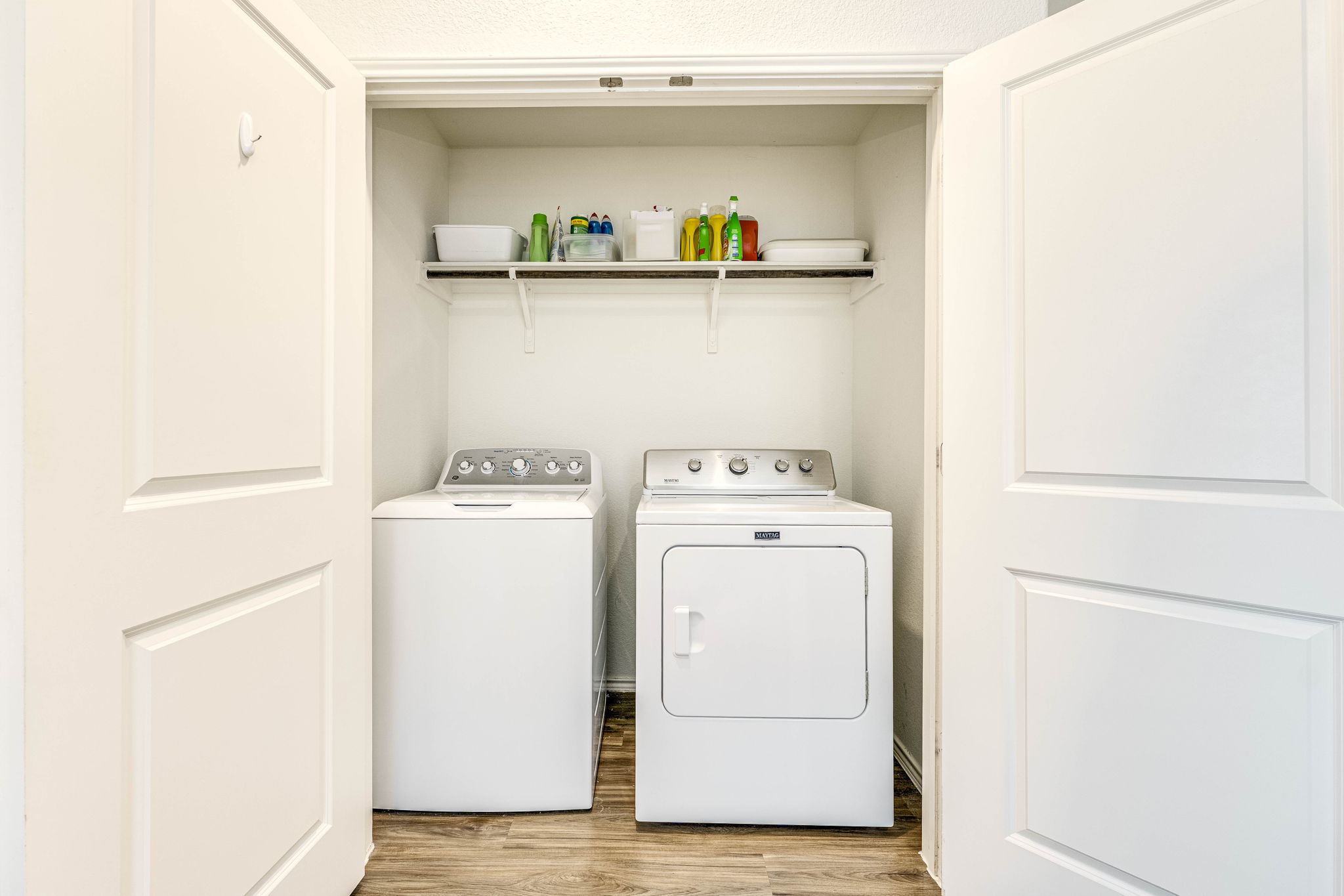 557 Greatest Gift Way Jarrell, TX 76537 - Photo 20 of 39 Laundry area featuring light wood-type flooring, a textured ceiling, and washer and clothes dryer