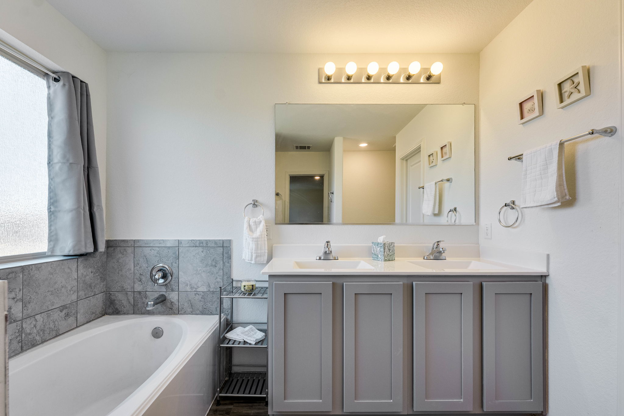 557 Greatest Gift Way Jarrell, TX 76537 - Photo 23 of 39 Full bathroom featuring double vanity and a bath