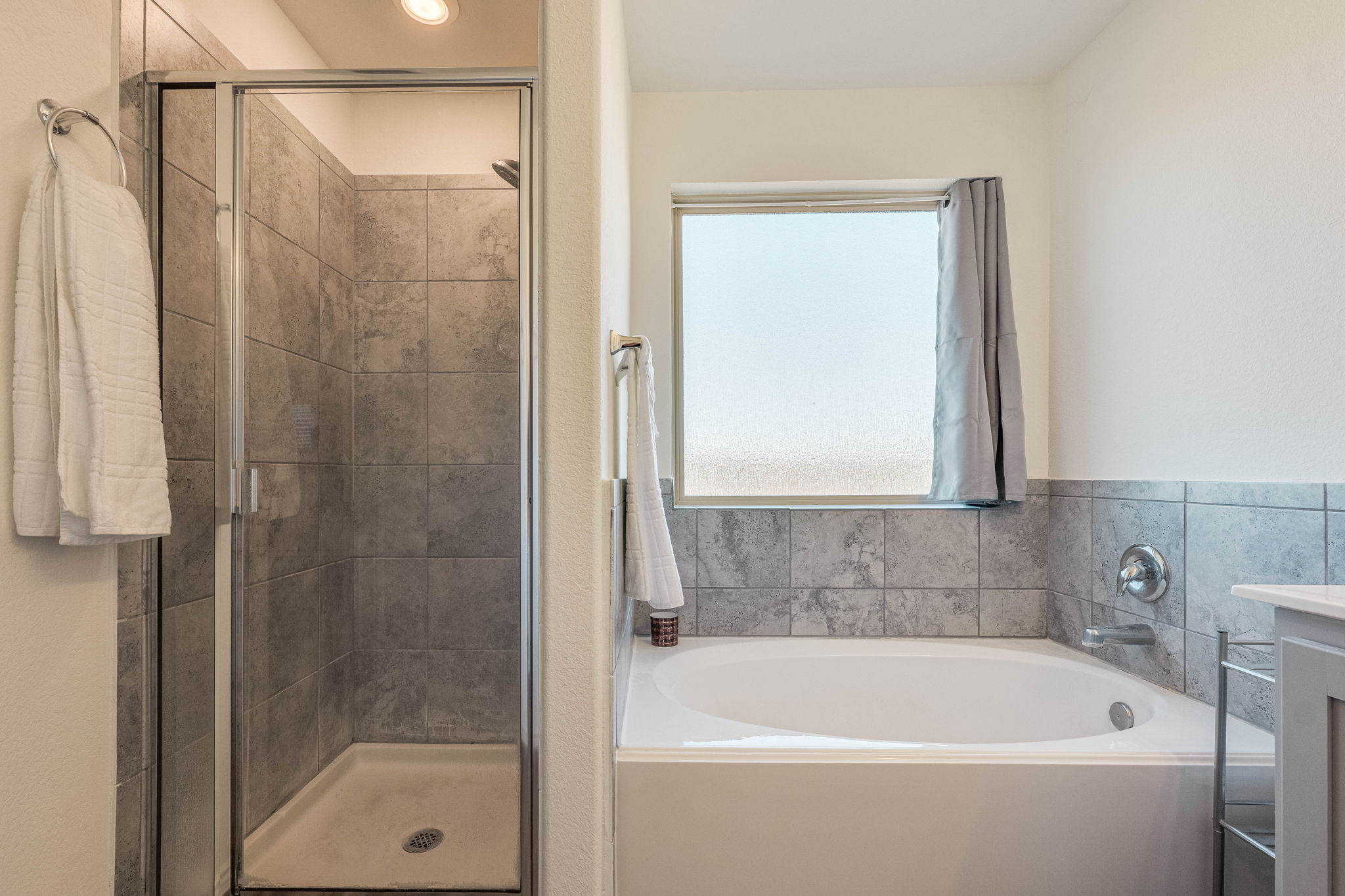 557 Greatest Gift Way Jarrell, TX 76537 - Photo 26 of 39 Full bath featuring a garden tub, vanity, and a shower stall