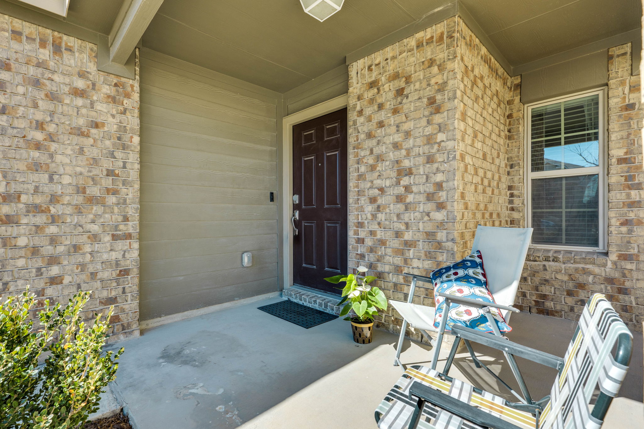 557 Greatest Gift Way Jarrell, TX 76537 - Photo 3 of 39 View of exterior entry featuring brick siding and covered porch
