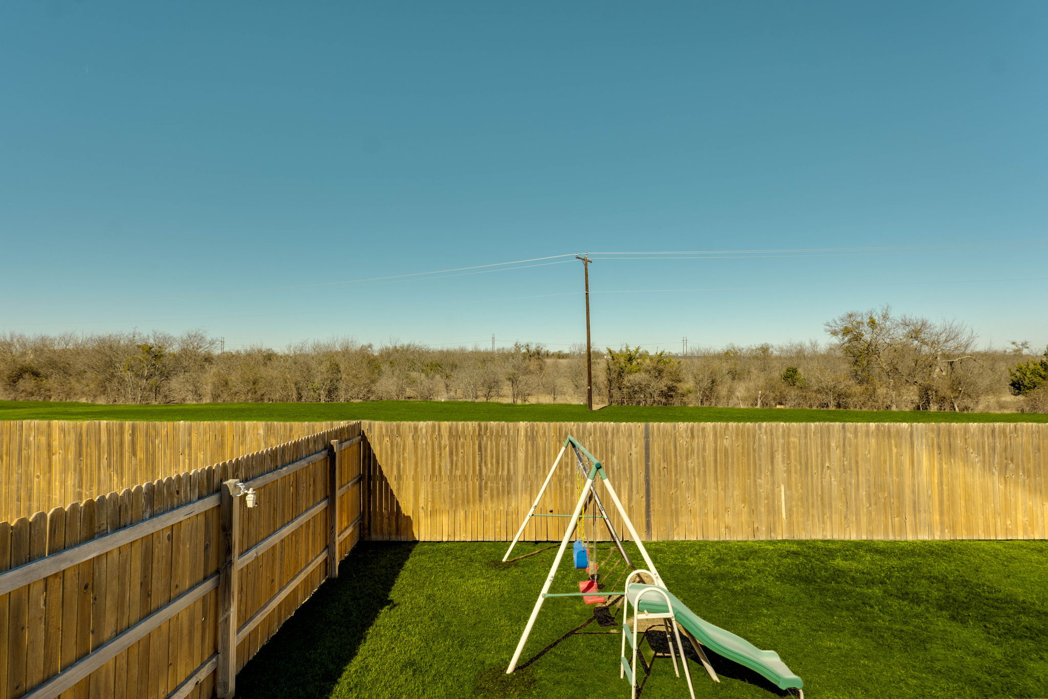557 Greatest Gift Way Jarrell, TX 76537 - Photo 30 of 39 Fenced backyard featuring a playground