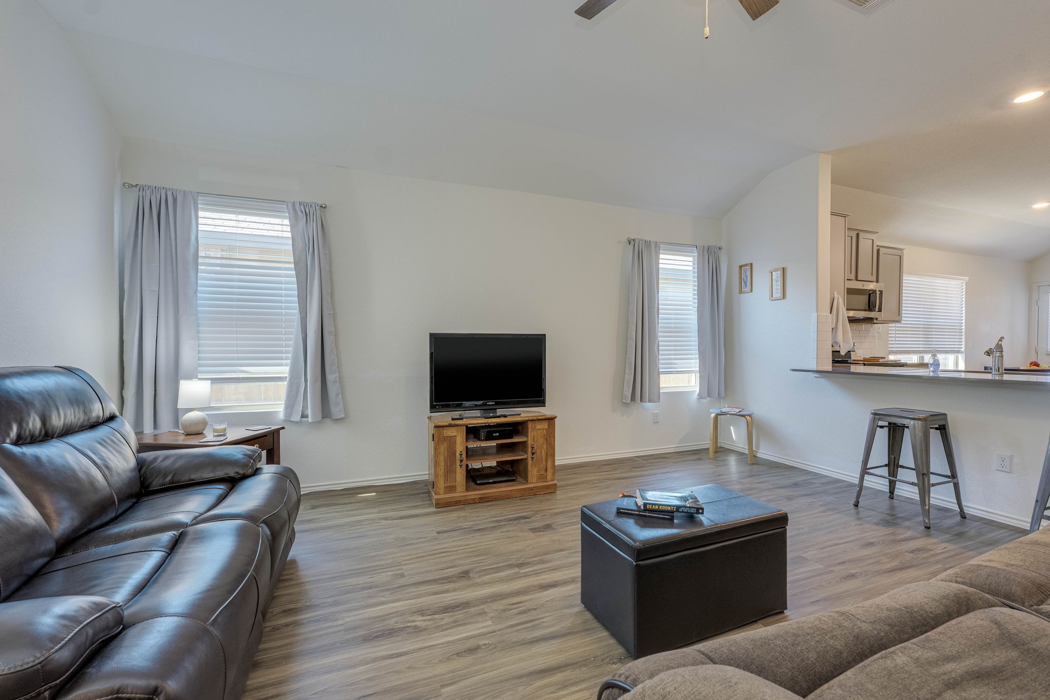 557 Greatest Gift Way Jarrell, TX 76537 - Photo 5 of 39 Living area with vaulted ceiling, wood finished floors, ceiling fan, plenty of natural light, and recessed lighting