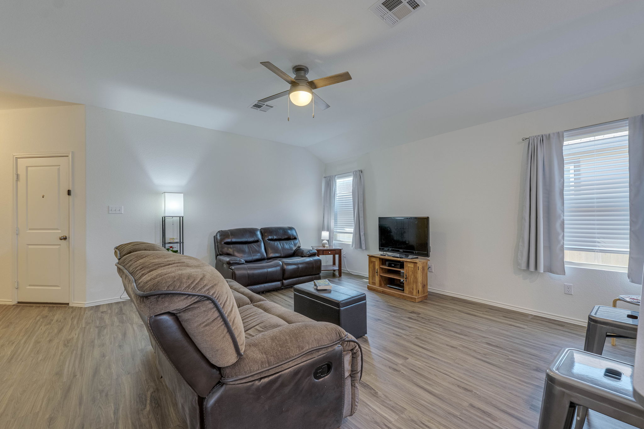 557 Greatest Gift Way Jarrell, TX 76537 - Photo 10 of 39 Living room featuring light wood-style floors, a ceiling fan, and vaulted ceiling